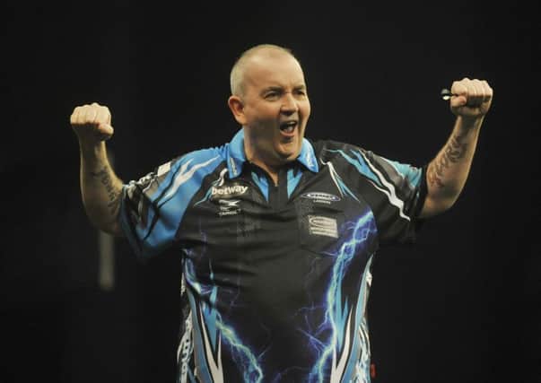 HE'S GOT THE POWER: Former world champion Phil Taylor ceLebrates his 7-4 win over Raymond van Barneveld in the Betway Premier League.