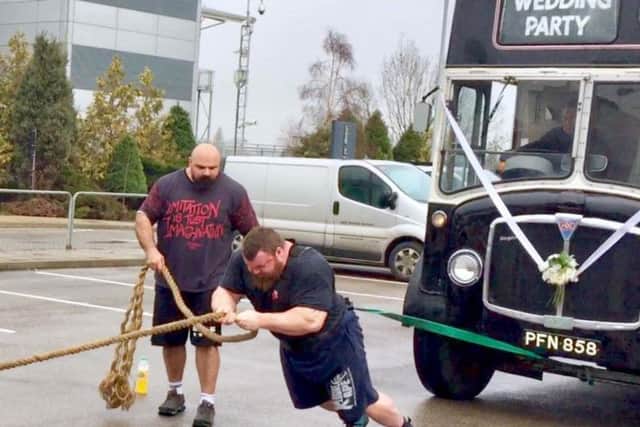 'The Beast' Eddie Hall - encouraged by Europes Strongest Man, Laurence Shahlaei - pulls eight-tonne vintage bus with his bare hands.