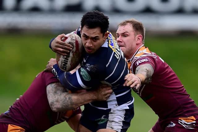Batley's Sam Smeaton and Dom Brambani (in his 300th game) get to grips with Featherstone's Chris Ulugai.