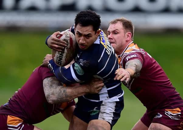 Batley's Sam Smeaton and Dom Brambani (in his 300th game) get to grips with Featherstone's Chris Ulugai.