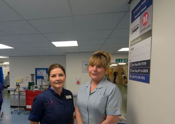 Breeda Columb, Head of Nursing, with Lisa Aldam, Non Clinical Support Worker, next to the new sign.