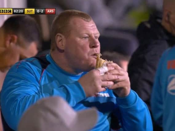 Wayne Shaw eating a pie during the game. Photo: BBC1