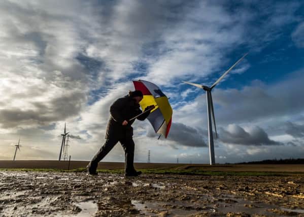 DIFFICULT DAY: A man is buffeted at Hook Moor wind farm in Leeds. PIC: James Hardisty