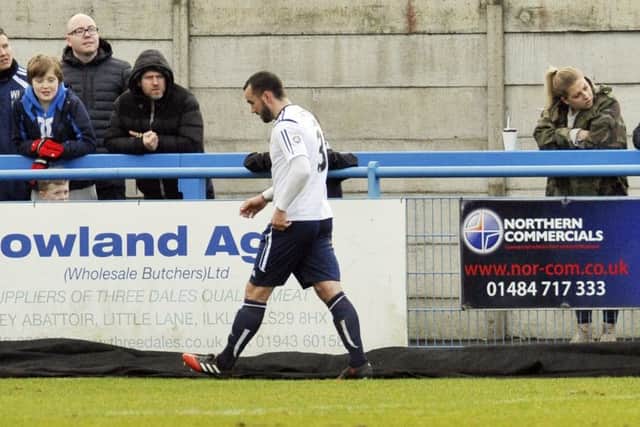 Danny Lowe trudges off the field after being sent off.
