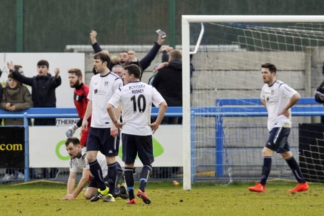 Guiseley players show their frustration after North Ferriby's late winner.