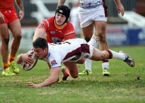 Batley's Alistair Leek goes over for the first try despite the efforts of Sheffield's Greg Burns.
 PIC: Jonathan Gawthorpe