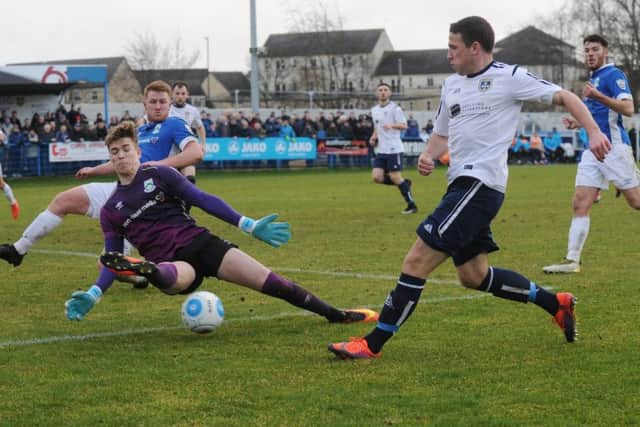John Rooney of Guiseley is foiled by North Ferriby United goalkeeper Ryan Watson on Saturday.