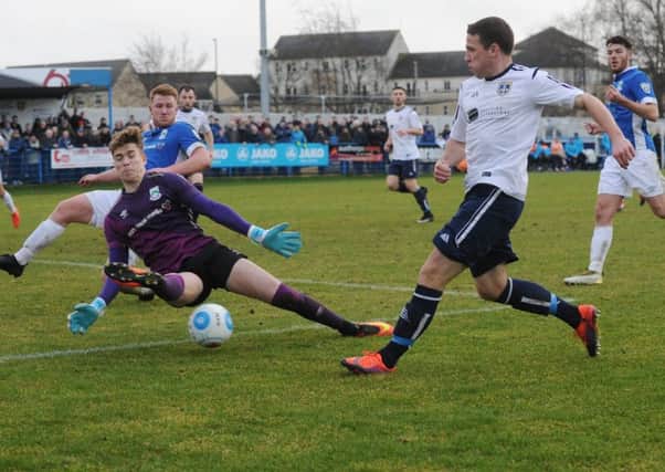 John Rooney of Guiseley is foiled by North Ferriby United goalkeeper Ryan Watson on Saturday.