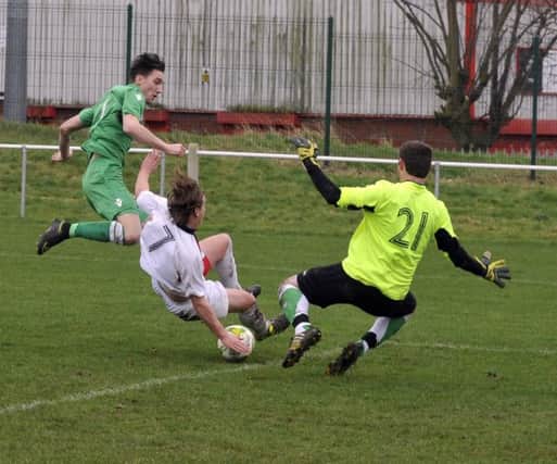Matty Nebard, of Beeston, is thwarted  by Callum Robinson and Matty Lewi,s of Leeds Modernians. PIC: Steve Riding