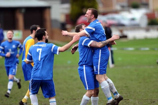 HT Sports' Byron Spink congratulates Steve Palfrey after his  goal straight from the kick off against Hope Inn Whites. PIC: Jonathan Gawthorpe