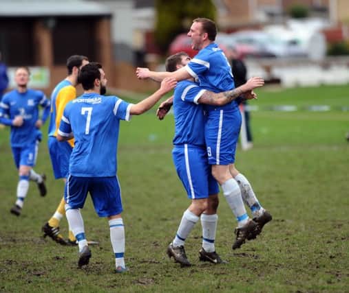 HT Sports' Byron Spink congratulates Steve Palfrey after his  goal straight from the kick off against Hope Inn Whites. PIC: Jonathan Gawthorpe