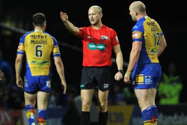 Referee Chris Campbell and Carl Ablett.