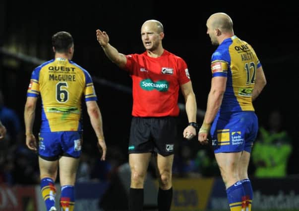 Referee Chris Campbell and Carl Ablett.