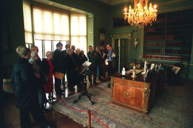 Visitors to Temple Newsam House, Temple Newsam, Leeds, were invited to have a close-up look at some of Chippendales furniture yesterday, (tuesday). In the picture curator James Lomax, right, is seen here showing some of the visitors a Chippendale library desk which was made for Harewood House in 1772 and is now on display at Temple Newsam House.