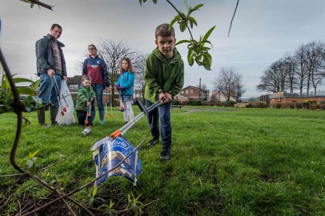 YEP Keep Leeds Tidy campaign.  Pictured are Andrew Scopes and wife Jean , with their children Jonah 3, Esther, 8, and Joel 7, volunteering to tidy a communal garden just off Town Street, Beeston, Leeds.  Pictures: James Hardisty