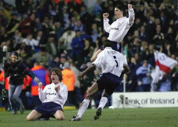 Leeds United's Ian Harte, back, Lucas Radebe, front right, and Harry Kewell, left, celebrate Kewell's goal for Leeds United against AS Roma at Leed's Elland Road.