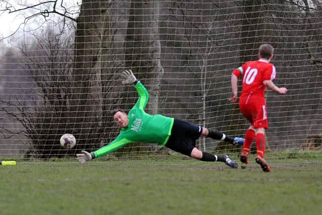 Josh Thornton scores a late equaliser from the penalty spot for Shire past Drighlington goalkeeper Ivan Willis. PIC: Steve Riding