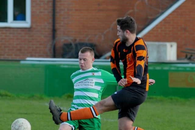 Sam Westerman, of Kippax, clears under pressure from Howden Clough's Joe Bedford. PIC: Steve Riding