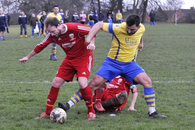 Matt Nicholson, of Shire, tangles with Ryan Rhodes, of Drighlington. PIC: Steve Riding