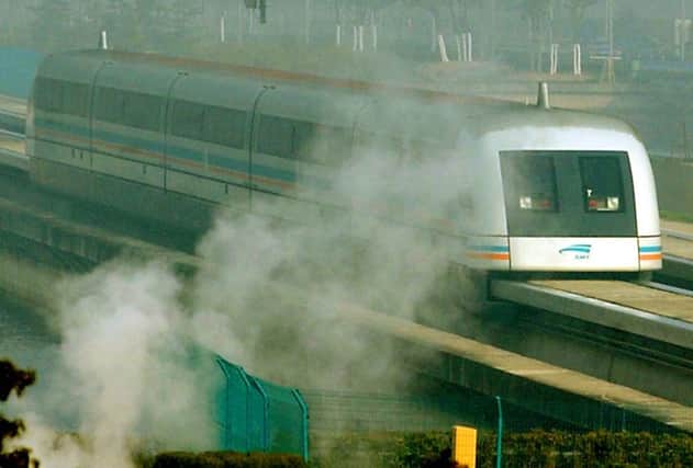 The magnetic levitation train runs though a steam cloud at Pudong International Airport station in Shanghai, China.