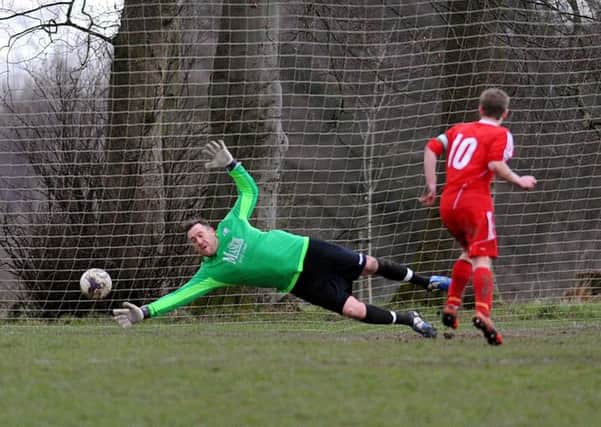 Josh Thornton scores a late equaliser from the penalty spot for Shire past Drighlington goalkeeper Ivan Willis