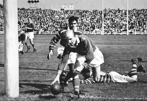 Lewis Jones of Leeds RL places the ball under the posts  at Headingley. He put the boot into Halifax on the way to Wembley in March 1957.