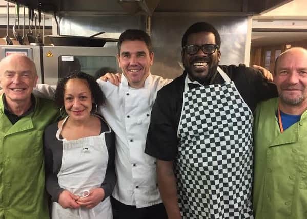 TEAMWORK: Kitchen staff at St Georges Crypt are helping to promote a food poverty campaign.