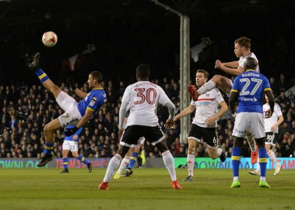 Kemar Roofe gets in an overhead shot at goal.
