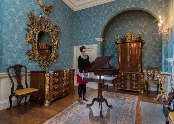 Rachel Conroy, curator at Temple Newsam, Leeds, admiring their newly acquired mechanised reading and writing desk expertly crafted more then 270 years ago.  PIC: James Hardisty