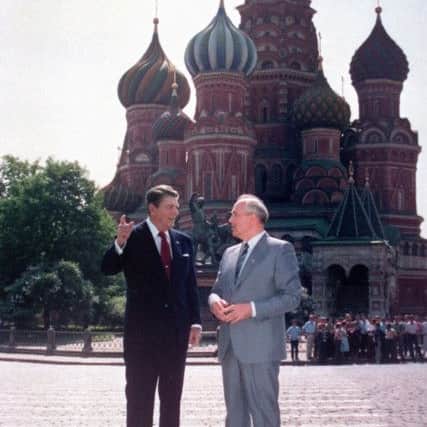 U.S. President Ronald Reagan, left, and Soviet leader Mikhail Gorbachev stand alone during their impromptu walk in Red Square in Moscow, USSR, Tuesday, May 31, 1988.  In the background is St. Basil's Cathedral. Reagan, the cheerful crusader who devoted his presidency to winning the Cold War, trying to scale back government and making people believe it was ``morning again in America,'' died Saturday, June 5, 2004, after a long twilight struggle with Alzheimer's disease. He was 93.  (AP Photo/Ira Schwartz)