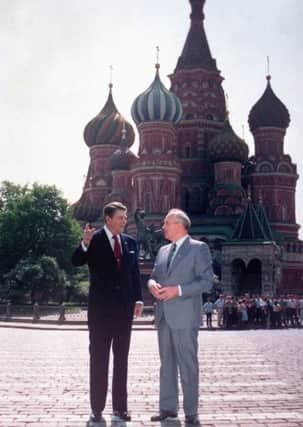 U.S. President Ronald Reagan, left, and Soviet leader Mikhail Gorbachev stand alone during their impromptu walk in Red Square in Moscow, USSR, Tuesday, May 31, 1988.  In the background is St. Basil's Cathedral. Reagan, the cheerful crusader who devoted his presidency to winning the Cold War, trying to scale back government and making people believe it was ``morning again in America,'' died Saturday, June 5, 2004, after a long twilight struggle with Alzheimer's disease. He was 93.  (AP Photo/Ira Schwartz)