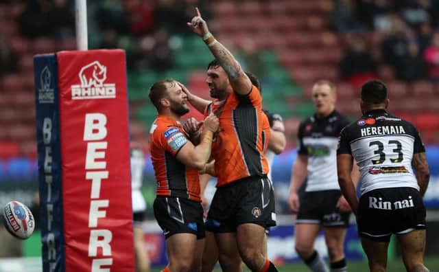 Castleford Tigers' Matt Cook (right) celebrates scoring a try with Paul McShane at Widnes: Nick Potts/PA
