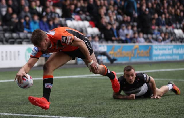 Castleford Tigers Mike McMeeken beats the tackle from Widnes Vikings Matt Whitley to score a try during the Betfred Super League match at the Select Security Stadium, Widnes. PIC: PA