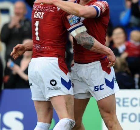 Scott Grix and Jacob Miller celebrate Wakefield's win over Salford yesterday. PIC: Jonathan Gawthorpe