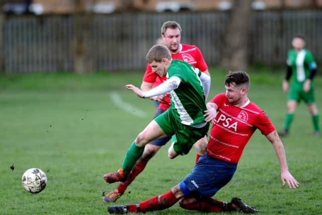 New Pudsey's Dave Thornton is tackled by Bramley's Danny Jacklyn during Sunday's Division One encounter. PIC: Jonathan Gawthorpe