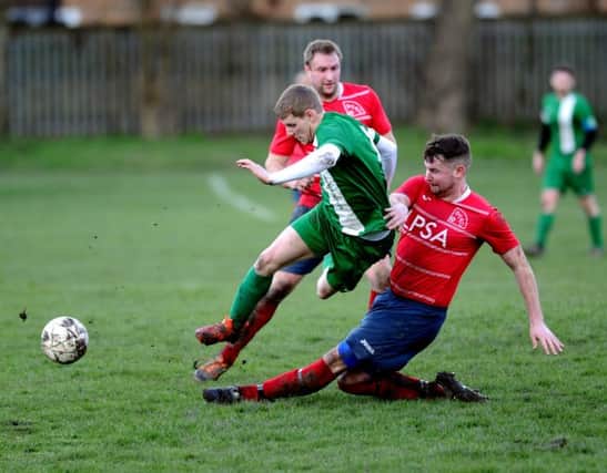 New Pudsey's Dave Thornton is tackled by Bramley's Danny Jacklyn during Sunday's Division One encounter. PIC: Jonathan Gawthorpe