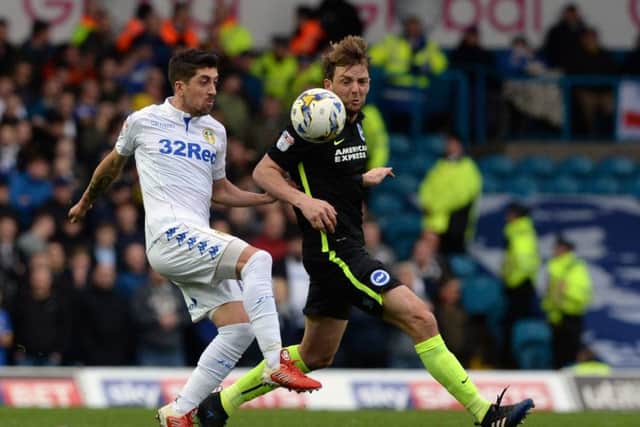 Pablo Hernandez and Dale Stephens challenge for the ball.