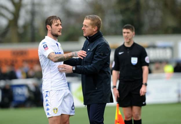 Man of the match contender Liam Cooper and Leeds head coach Garry Monk.