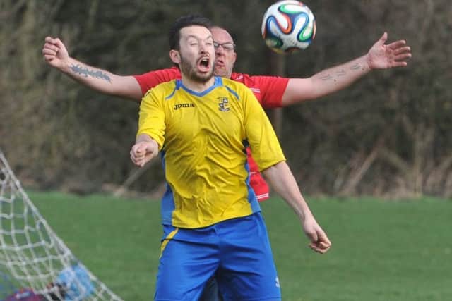 Oulton goalscorer Liam Atkinson holds the ball up from Bramleys Anthony Thorpe. PIC: Tony Johnson