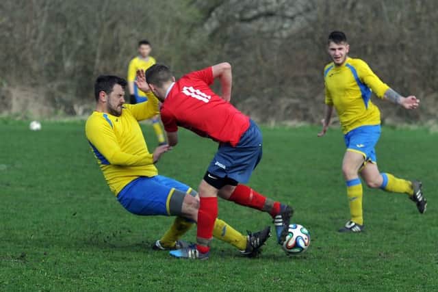 Oulton's Mattew Bridges puts in a strong tackle on Bramley's Marc Wilson. PIC: Tony Johnson