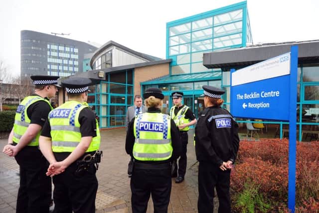 Police officers briefing outside the Becklin Centre in Leeds on Monday. Pictures by Simon Hulme.