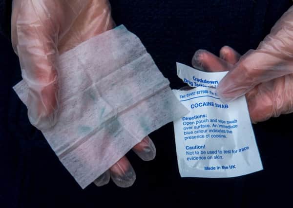 The wipes in the drug testing kits turn blue where they come into contact with cocaine.