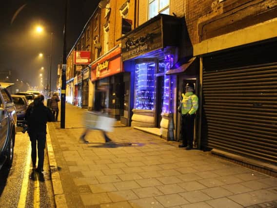 A police officer stands outside an address in Hagley Road, Birmingham, where armed police have raided a flat overnight. West Midlands Police have directed media queries to the Met Police, who have refused to discuss the incident for operational reasons.