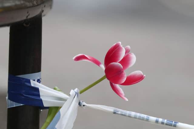 PABESTA flower tied to police tape outside the Queen Elizabeth II Centre in London, after seven people were arrested in raids in London, Birmingham and elsewhere linked to the Westminster terror attack. PRESS ASSOCIATION Photo. Picture date: Thursday March 23, 2017. See PA story POLICE Westminster. Photo credit should read: Gareth Fuller/PA Wire