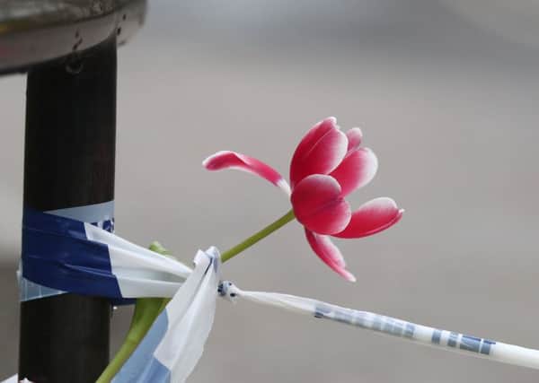 PABEST

A flower tied to police tape outside the Queen Elizabeth II Centre in London, after seven people were arrested in raids in London, Birmingham and elsewhere linked to the Westminster terror attack. PRESS ASSOCIATION Photo. Picture date: Thursday March 23, 2017. See PA story POLICE Westminster. Photo credit should read: Gareth Fuller/PA Wire