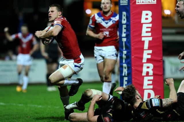 Wakefield's Jacob Miller celebrates his try.