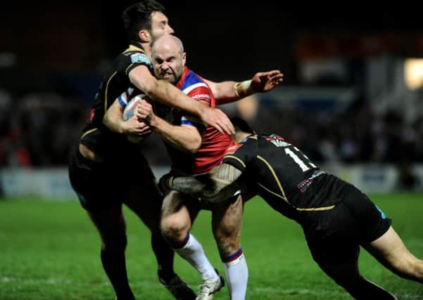 Wakefield's Liam Finn is tackled by Leigh's Harrison Hanson and James Green. PIC: Jonathan Gawthorpe