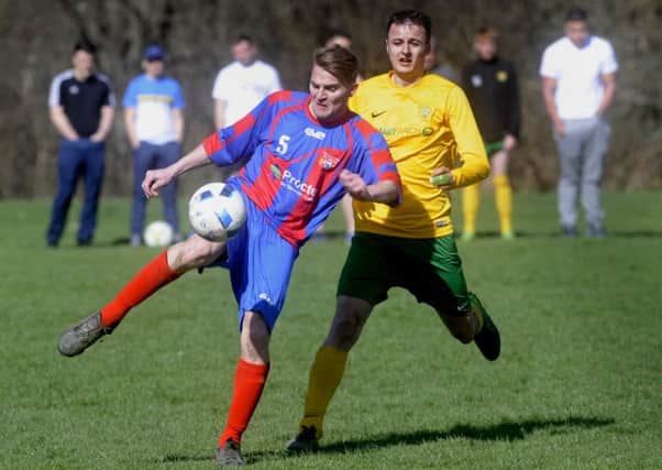 Swillington player James Donbavand clears the ball.