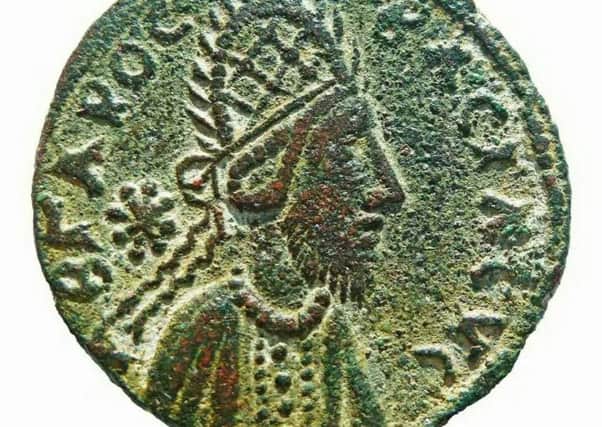 The tiny bronze coin, dating from the 1st-century AD, has what an author says is the only lifelike image ever made of Jesus.