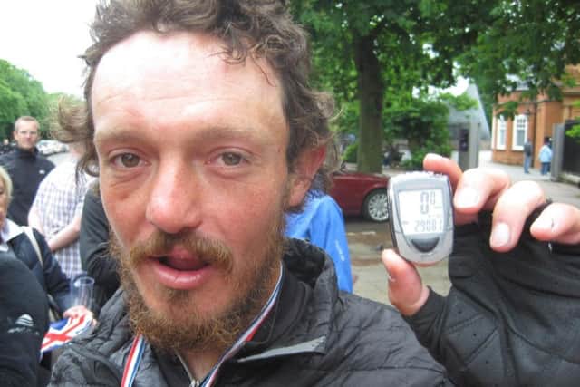 Mike Hall with his pedometer at Greenwich Royal Observatory in south-east London after he won a round-the-world bike race in 2012